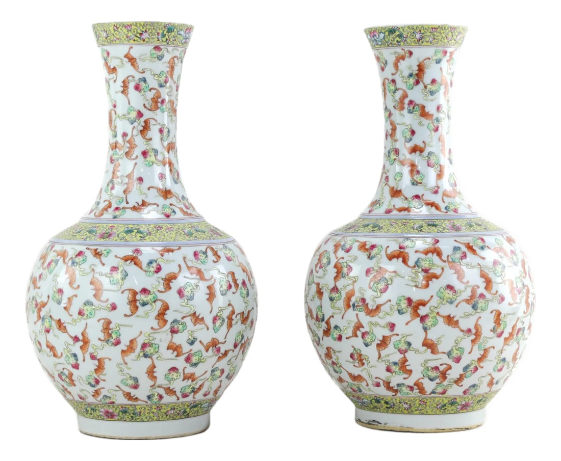A Pair of Mid-20th-Century Chinese Famille Rose Long-Necked Vases: The vase's main decorative features include amber-red bats and famille rose flowers. The base has the inscription "Made in the Qianlong Period" in red seal script. This mid-20th-century imitation Qian