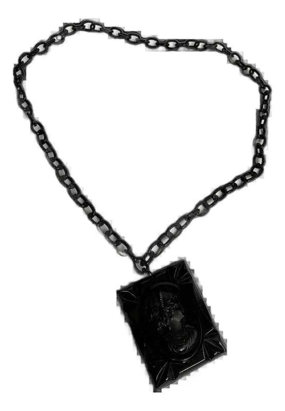 1940s Black Celluloid Cameo Necklace: Stunning celluloid pendant and cameo. This is a very large cameo measuring 1 3/4" wide and 2 1/4" long. The entire pendant measures 15 1/2" long. Dating from the 30's, this gothic necklace features th