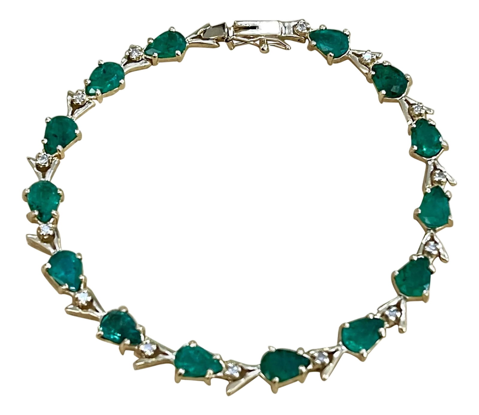 7 Carat Natural Brazil Emerald and Diamond Tennis Bracelet 14 Karat Yellow Gold: This exceptionally affordable Tennis bracelet has 14 stones of Pear shape Emeralds . Each Emerald is spaced by a single diamond . Total weight of the Emeralds is approximately 7 carat. Total number