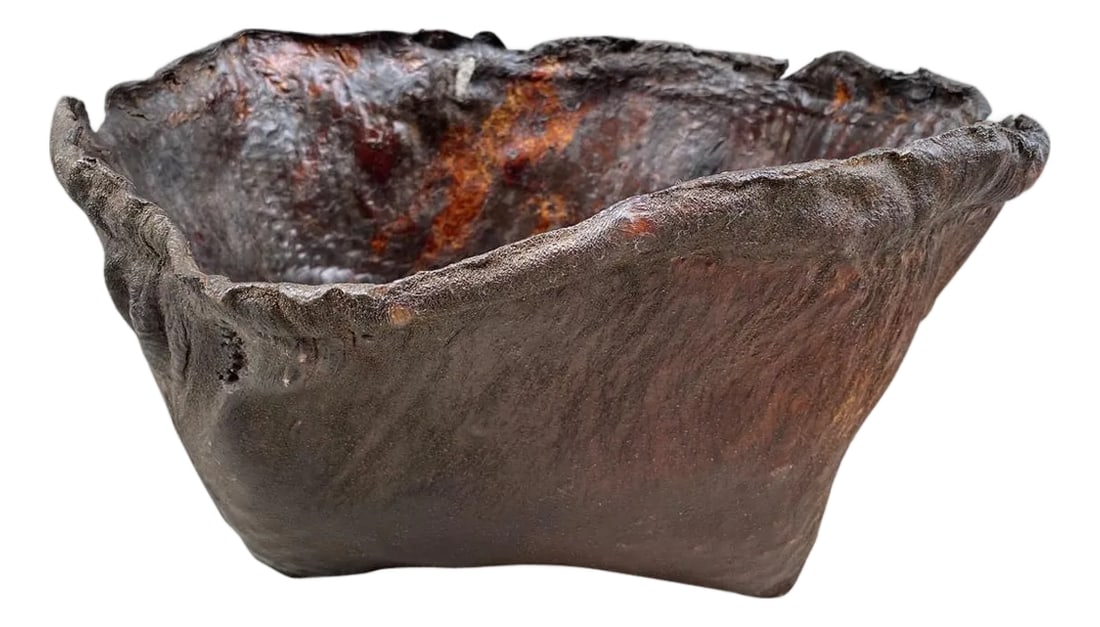 Polished Buffalo Hide Container: Antique container from Borneo made from aged buffalo hide with a natural organic live edge rim. We discovered a beautiful patina after polishing. Great for holding magazines, towels, or simply as a