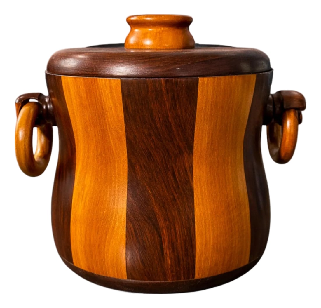 1960s Ice Bucket in Imbuia and Brazilian Hardwood, Unknown - Lot 179: Crafted in richly figured imbuia and Brazilian rosewood (jacarandÃ¡), this sculptural ice bucket highlights the expressive beauty of contrasting hardwoods. Vertical bands of warm, honey-tone