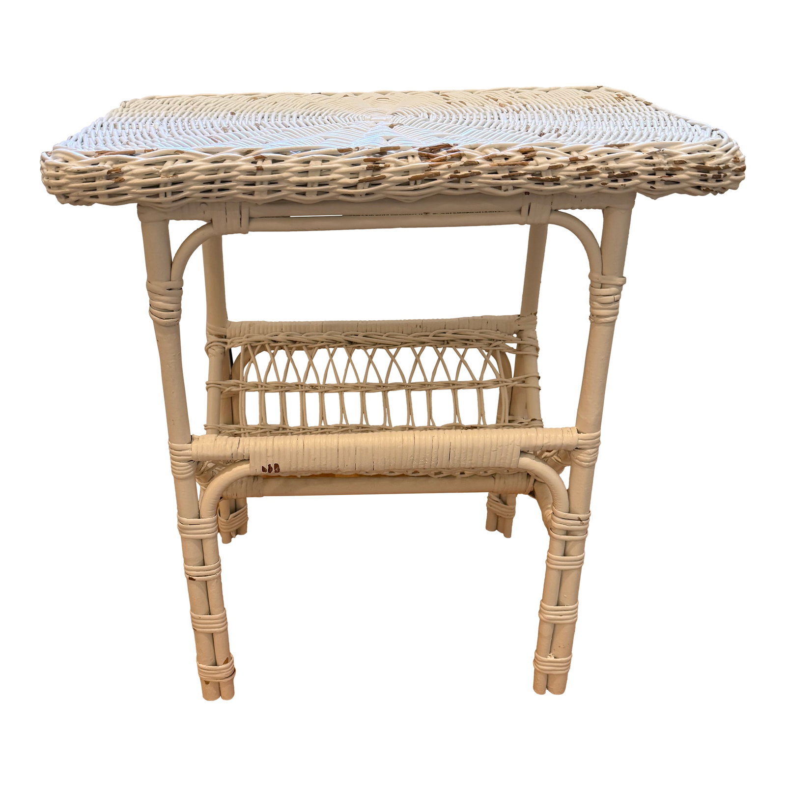 Wicker Side Table With Magazine Rack: Adorable white painted wicker side table with magazine rack storage underneath. Significant chipping commensurate with use and age. Priced for repainting. 22.75"W x 14.5"D x 24"H clearance: 6.5" Condi