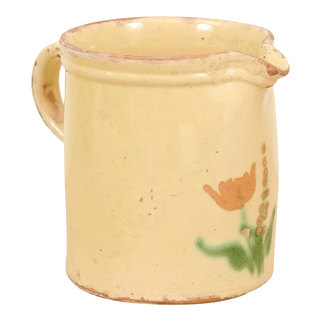 French 19th Century Cream Glazed Terracotta Pitcher with Floral Décor: A French cream glazed terracotta pitcher from the 19th century, with floral décor. Created in France during the 19th century, this pitcher features a circular cream glazed body adorned with
