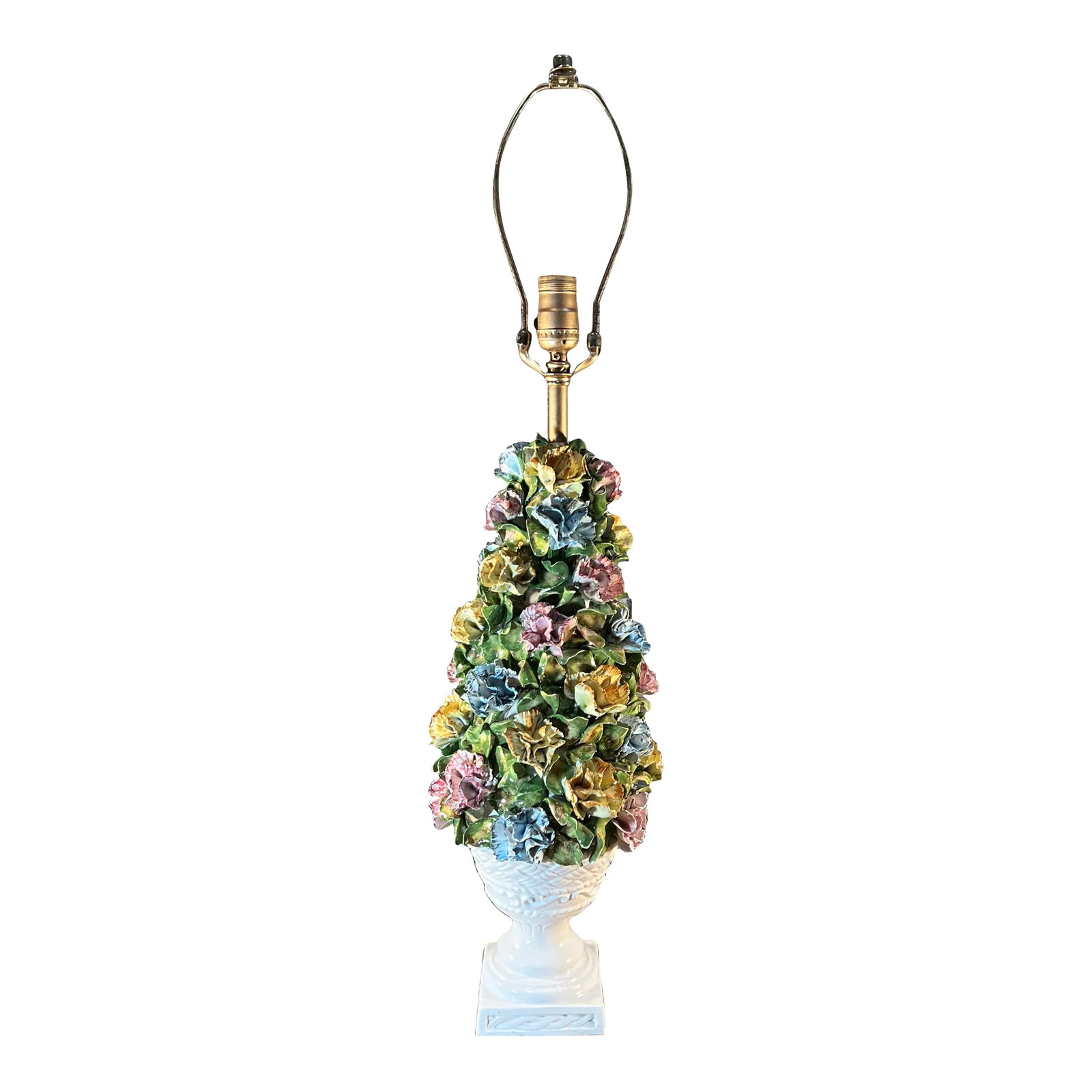 Mid-Century Capodimonte Porcelain Carnation Topiary Table Lamp: Mid-century Capodimonte handcrafted and hand painted porcelain topiary table lamp adorned with detailed yellow, blue, and pink carnations in a white urn. Resting on a gold-painted wood base, the lamp 