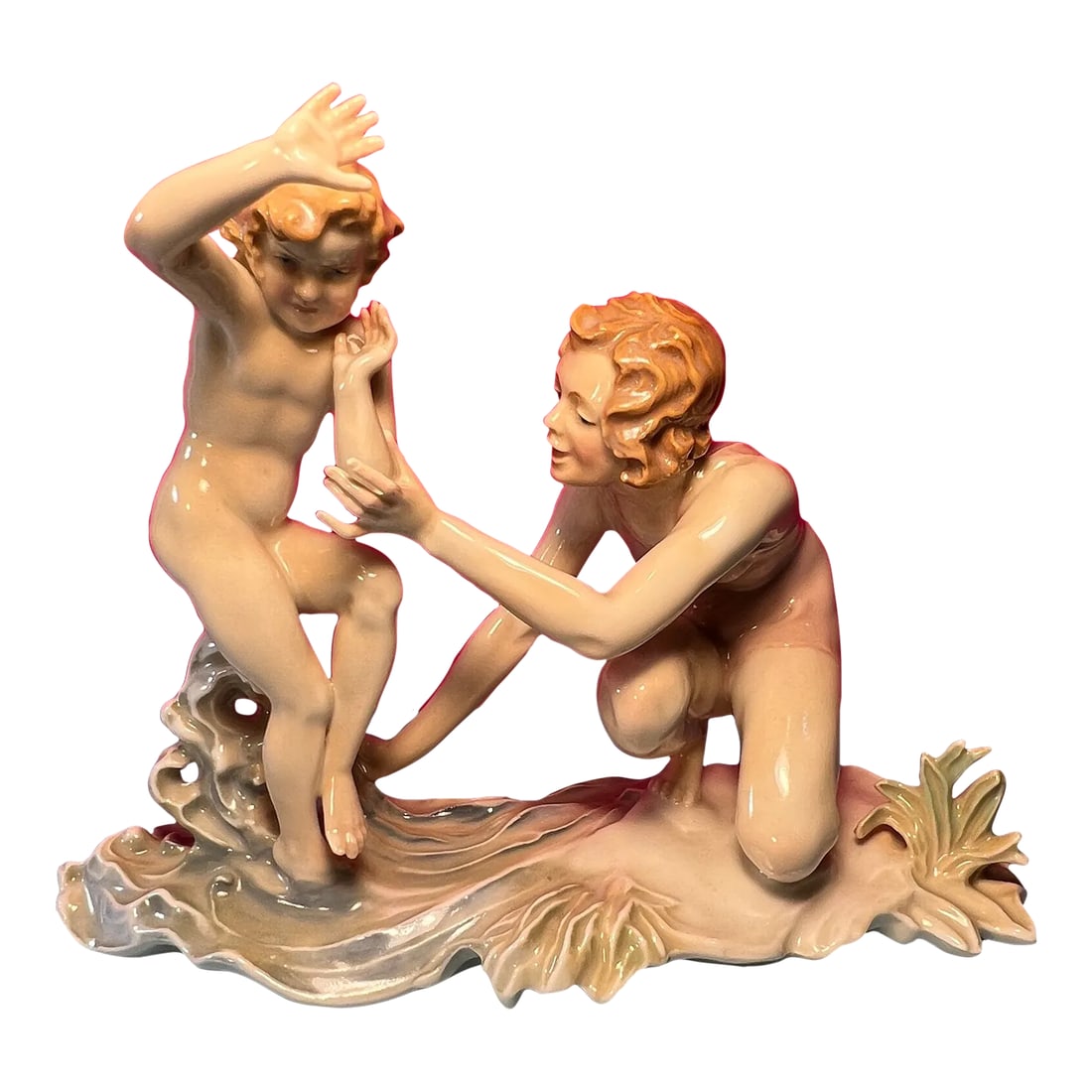 Karl Ens Figurine Mother Child Beach: This charming porcelain figurine, skillfully crafted by the renowned Karl Ens Porcelain Company in Germany, beautifully captures a heartwarming and idyllic moment between a mother and her toddler at