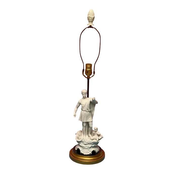 Vintage Table Lamp: Porcelain Bisque Young Man Cherub Seashell: This vintage white bisque table lamp features a gracefully detailed figure of a youth in a toga, standing on a large clamshell. The design evokes a subtle nod to Botticelli's "Venus," with the