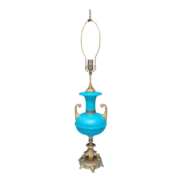 Mid-Century Blue Brass Table Lamp: This exquisite vintage lamp captivates with its soft robin's egg blue hue, that beautifully contrasts with the intricate gold accents. The lamp's body is short and bulbous. It transitions smoothly int