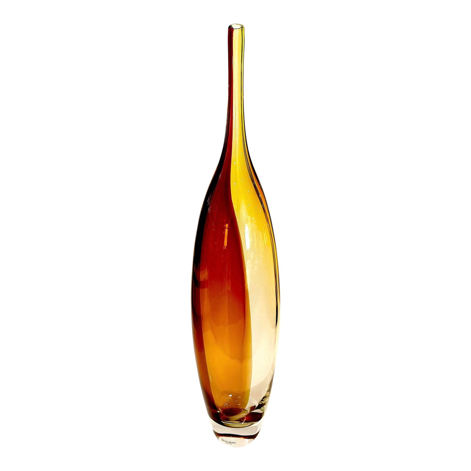 1990's Kosta Boda "Tobago" Vase by Kjell Engman - Signed: This beautiful vase was produced by Kosta Boda sometime in the 1990's. Gorgeous tones of amber, gold, and pale brown trail up its entire body. Purposefully elongated to make a sleek yet elegant statem