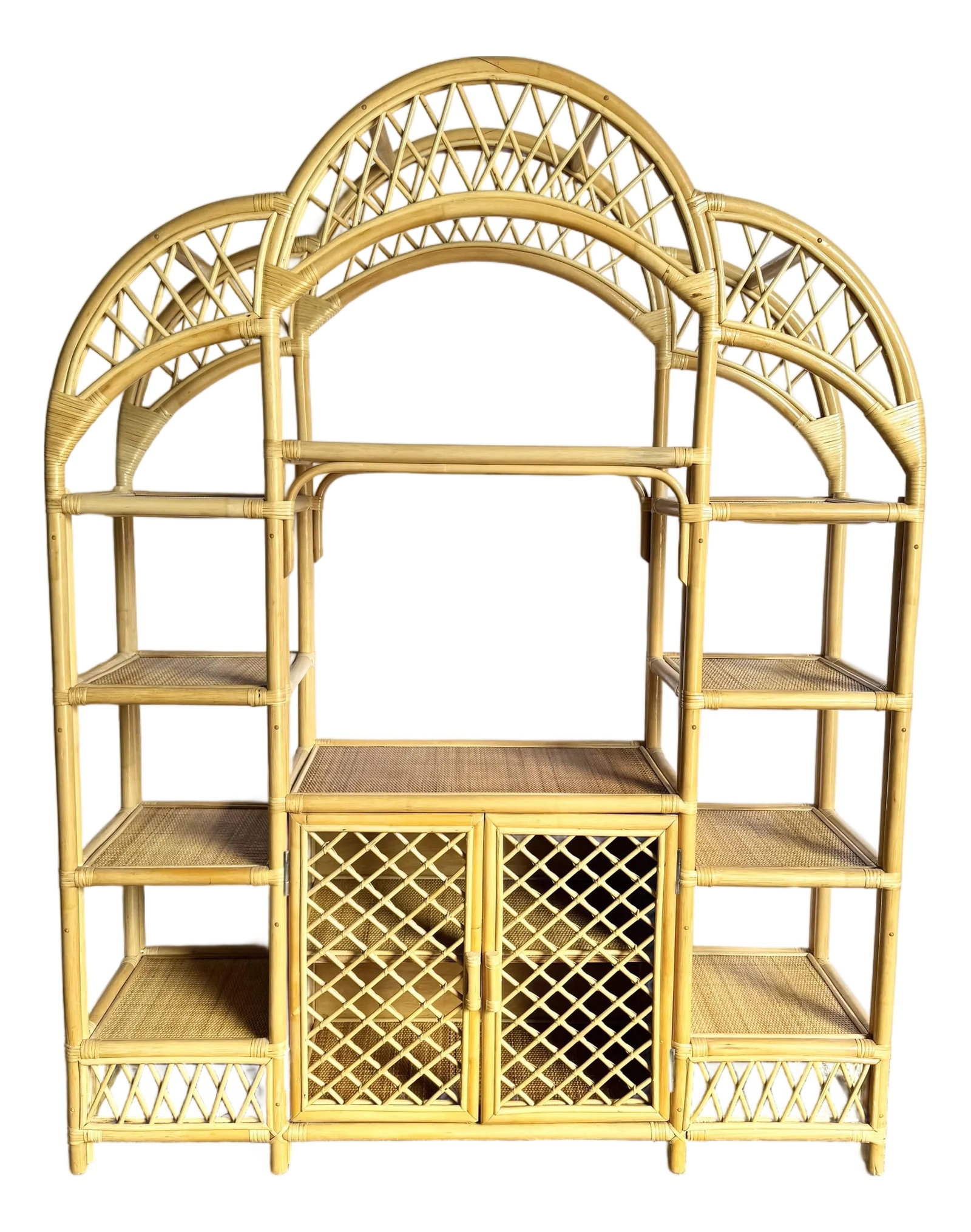 Boho Chic Arched Rattan Etagere/Wall Unit: This Boho Chic arched rattan étagère captures coastal charm and natural elegance in a versatile wall unit design. Featuring airy lattice doors and open shelving, it combines display and stor