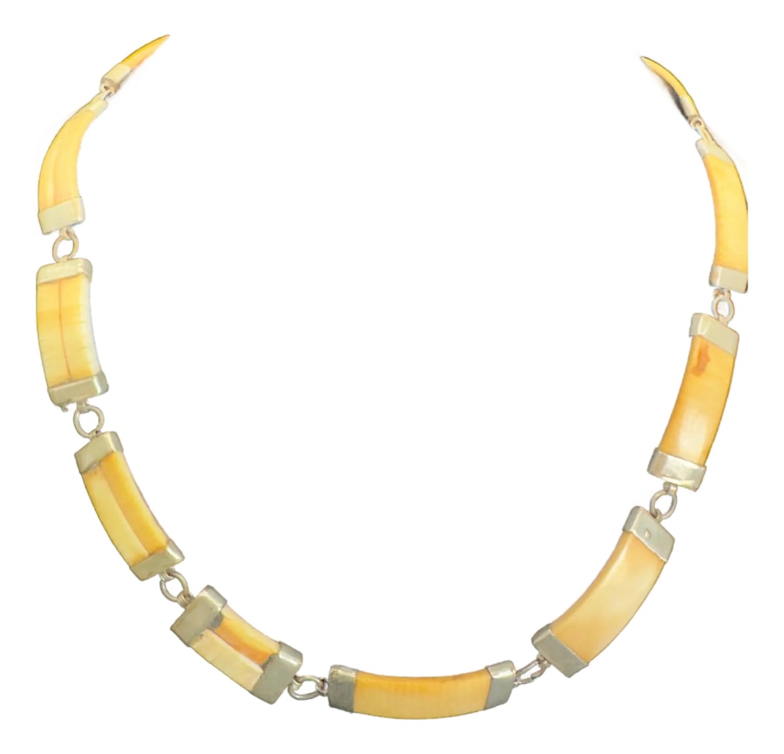 1960s African Wild Warthog Tusk Necklace: Vintage African Wild Warthog Tusk Necklace, White Brass. Unisex in design, unique find. Each piece of curved tusk segments hold their own patina and beauty. Necklace has white brass capped ends to
