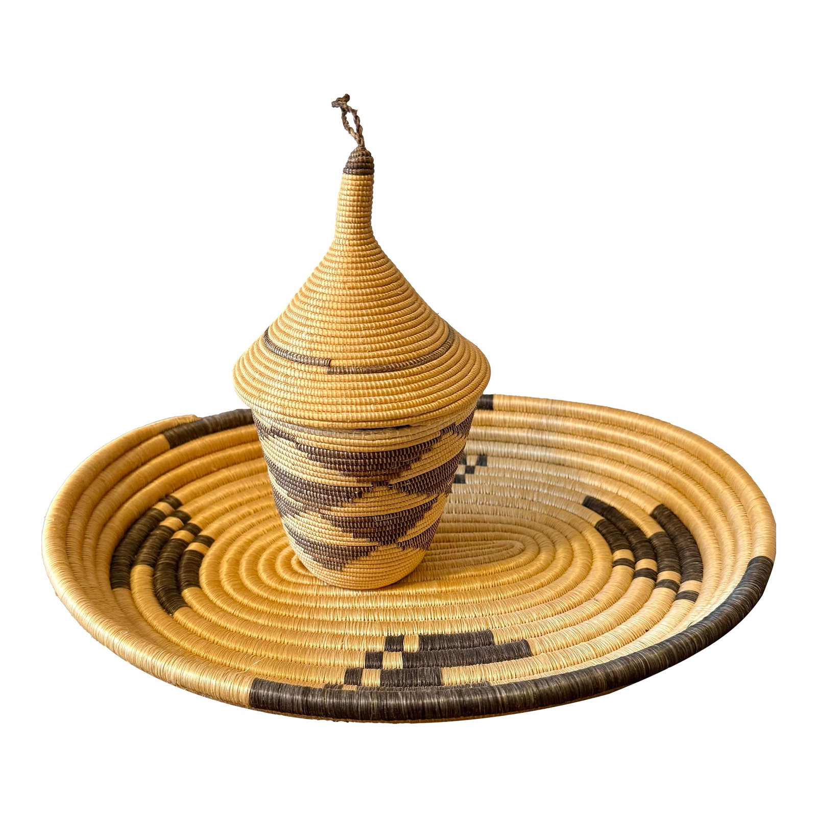 Rwandan Tutsi Woven Basket With Large Tray: Rwandan Tutsi handwoven baskets are known for their fine craftsmanship and tight stitches. They are symbolic of peace, unity and prosperity. This set features a beautifully crafted conical lidded