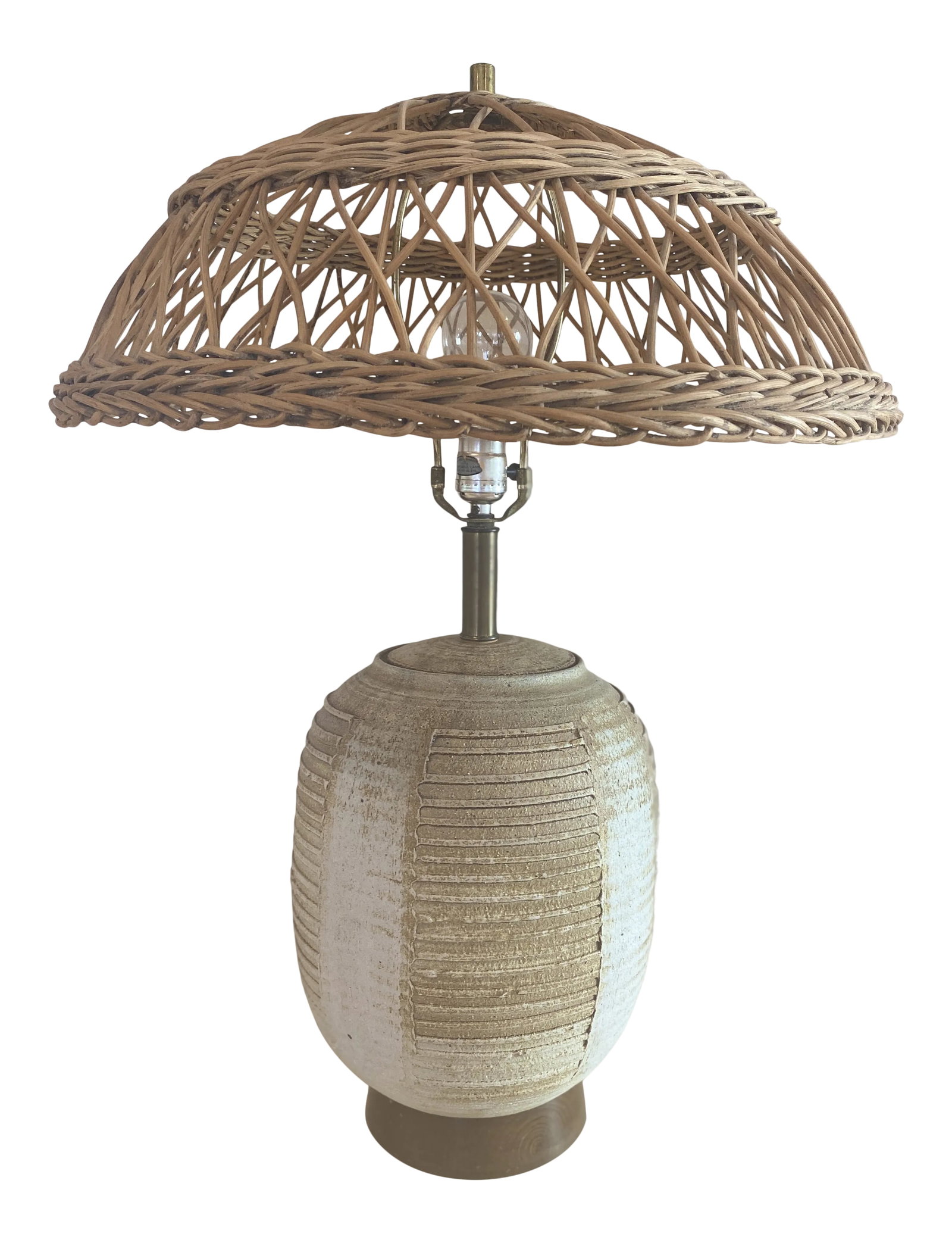Midcentury Striated Pottery Table Lamp With Wicker Shade: Midcentury taupe/beige pottery lamp with striated design. Brass base and fittings. Wicker shade. Single socket, 40W max, wired for USA. 9" Diam x 29"H Base: 6.5" Diam. H w/o Shade: 24" Condition: Alte