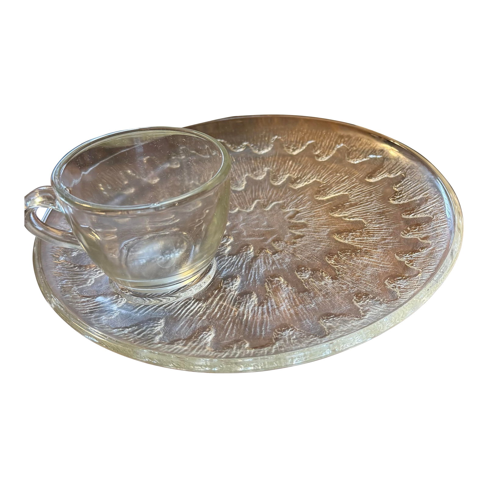 Indiana Glass Snack Plate Set - 24 Piece: This elegant set of 12 snack plates and 12 cups features the "Sunburst" pattern radiating from the center. The clear pressed glass construction gives it a durable yet elegant appearance,