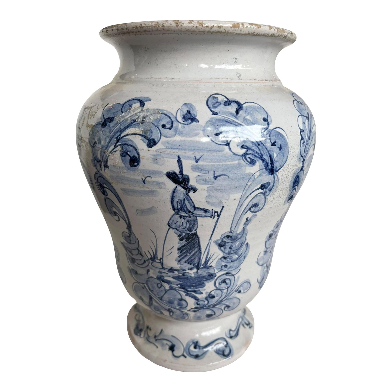 Antique Italian Blue and White Pottery Vessel: A character rich Italian pottery vessel, hand-painted in cobalt blue on a creamy white ground. The decoration features a central figure framed by scrolling foliate motifs, executed in a loose,