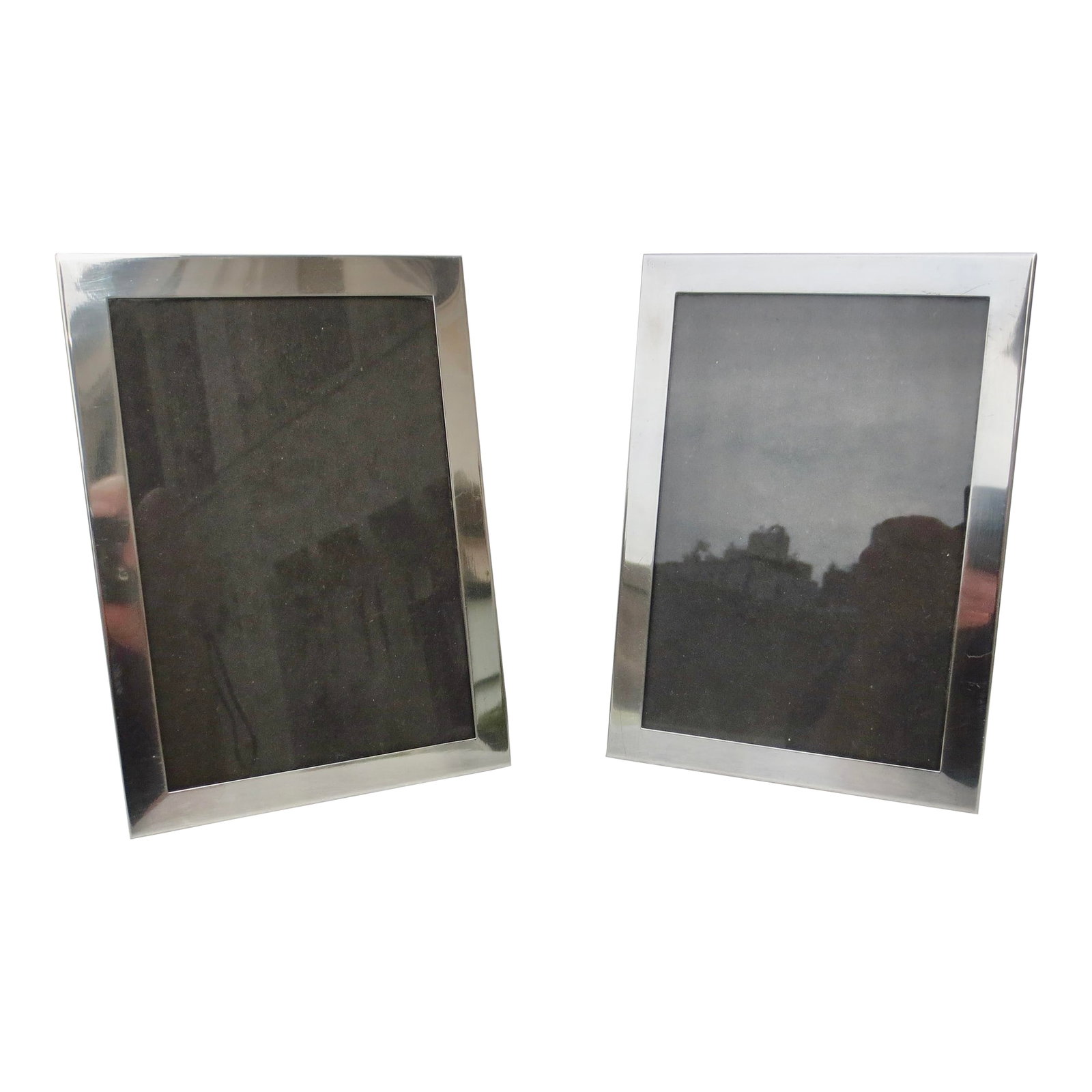 Reed and Barton Sterling Silver Photo Frames- A Pair of 2 (6 X 8): Matching pair of sterling silver photo frames. Marked to the frame Reed & Barton Sterling. Measurements are 6" by 8" overall, and the window is 5" by 7." Orientation is vertical or horizontal. Very cl