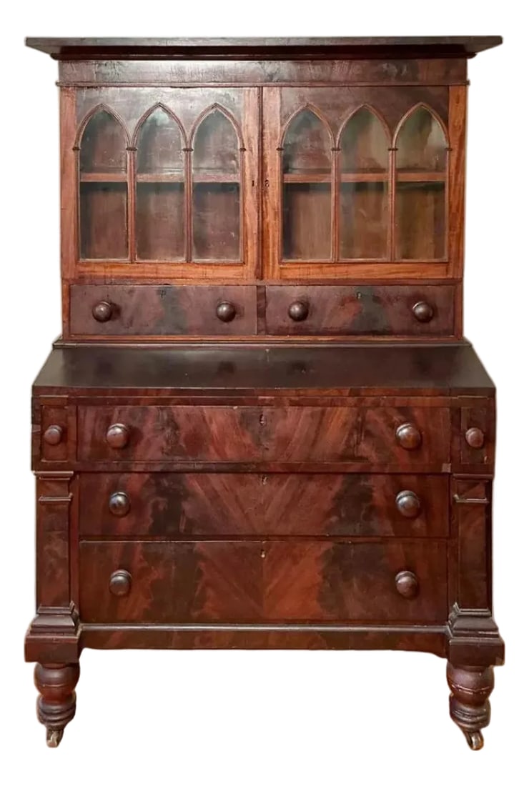 Antique American Federal Style Flame Mahogany Secretary-Bookcase Early 1800: Two piece unit. The upper features a rectangular molded top, over two cabinet doors with Gothic style glass windows opening to interior storage space with one shelf, over two drawers. The lower featur