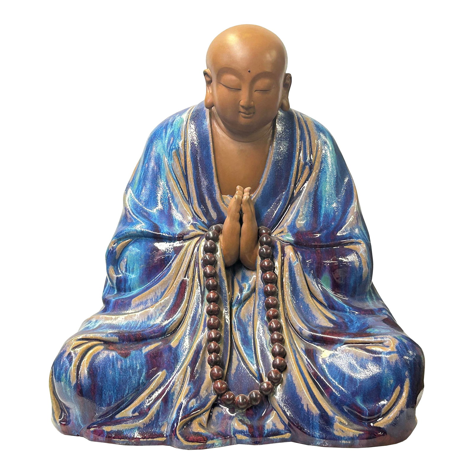 Fine Chinese Shiwan-Style Ceramic Luohan Amitabha in Deep Sea Glaze: This ceramic sculpture depicts a seated monk or Buddhist figure in a state of deep meditation. The figure is draped in a flowing, voluminous robe characterized by a striking reactive glaze, which feat