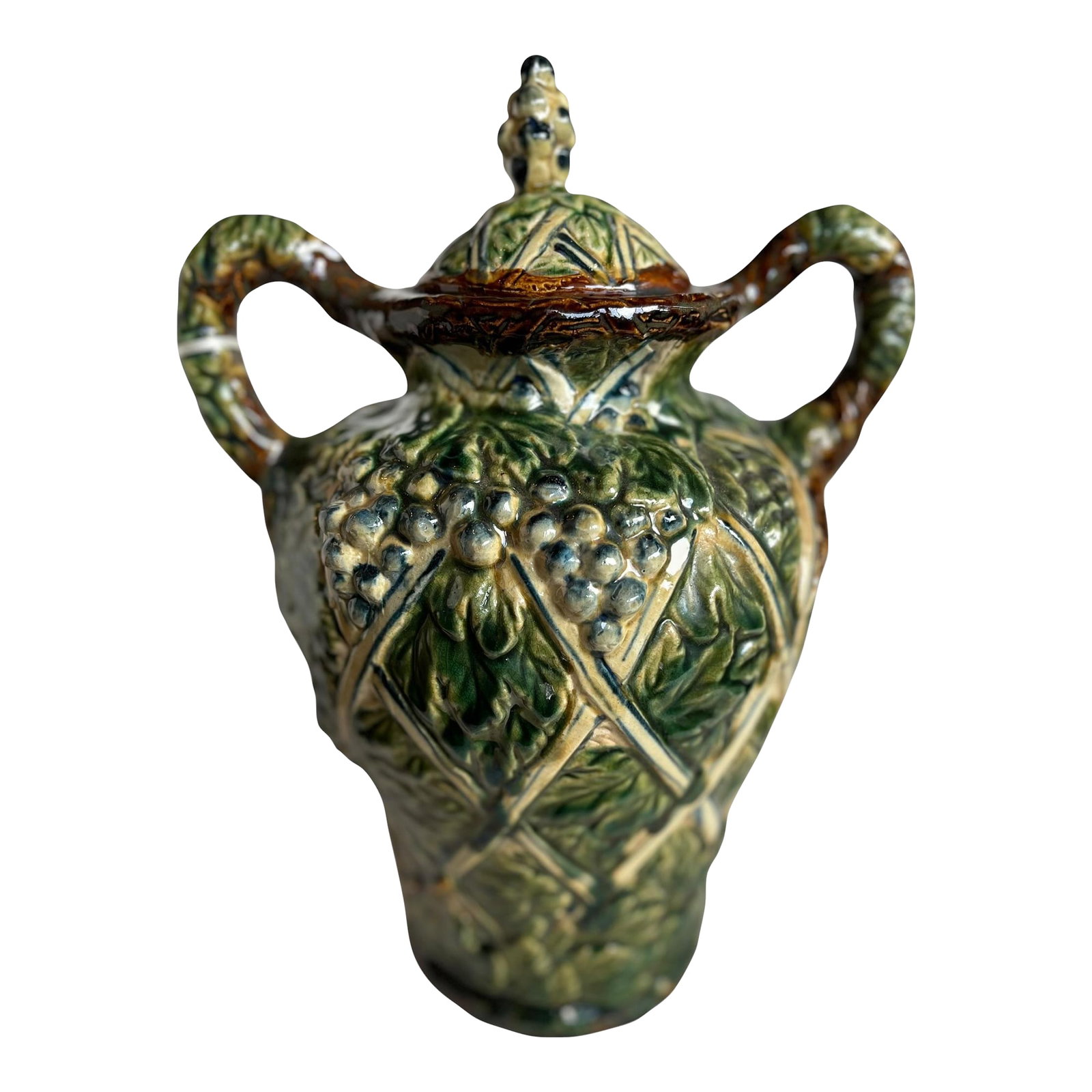 Mid 20th Century Lidded Urn: Mid 20th century lidded urn with handles, featuring a richly detailed majolica grapevine motif. The glazed surface carries vibrant tonal variation and sculptural relief, with classical vine and fruit 