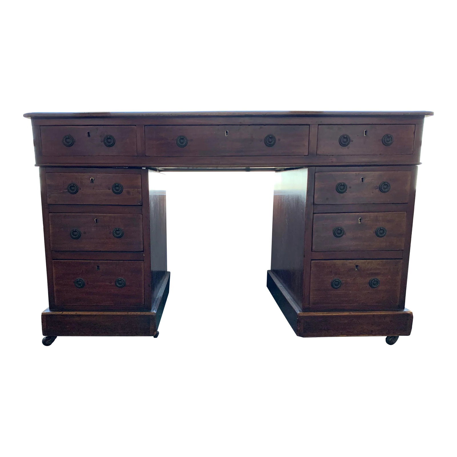Antique American Colonial Wood Desk: Antique American Colonial Wood Desk with full chest. The top is black tooled leather with hand painted gold leaf detail. The desk is wood with a medium walnut finish on four brass casters. Condition: 