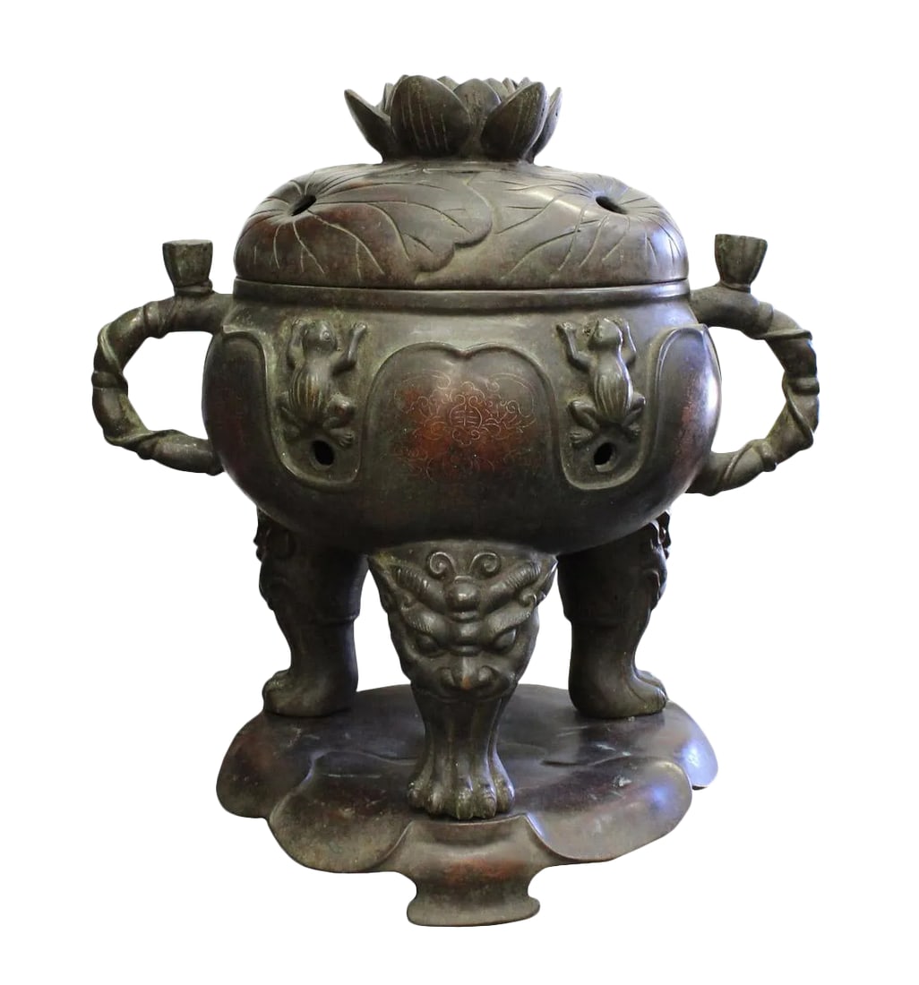 Vintage Chinese Lotus Theme Metal Ding Shape Incense Burner: This ornate bronze incense burner, or censer, stands as a striking example of traditional East Asian metalwork, characterized by its deep, aged patina and intricate mythological motifs. The vessel is