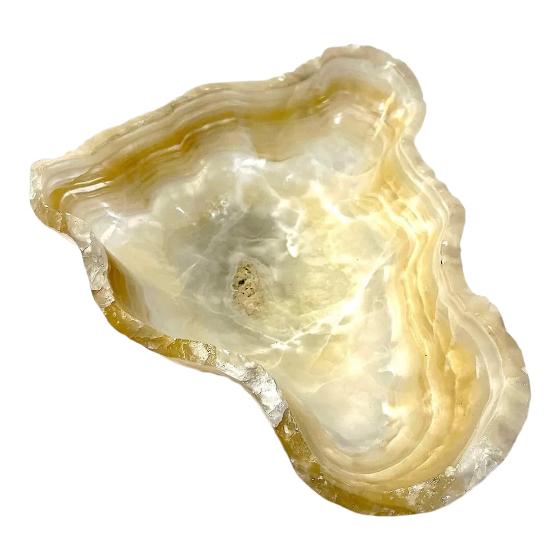 Vintage Carved Onyx Live Edge Bowl: Carved out of a solid piece of onyx - this magnificent bowl is naturally amazing. Its sinuous free form shape inundates with the organic flow of the stone itself. Translucent layers culminating in a
