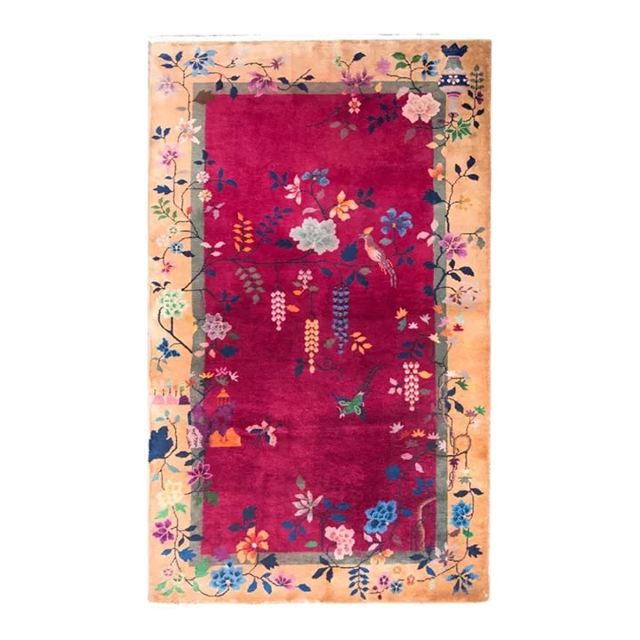 Early 20th Century Chinese Art Deco Rug: A beautiful early 20th century Chinese Art Deco rug with a fuchsia background, champagne colored border, and overlaid with myriad auspicious flowers including peonies, chrysanthemums, and branch with 