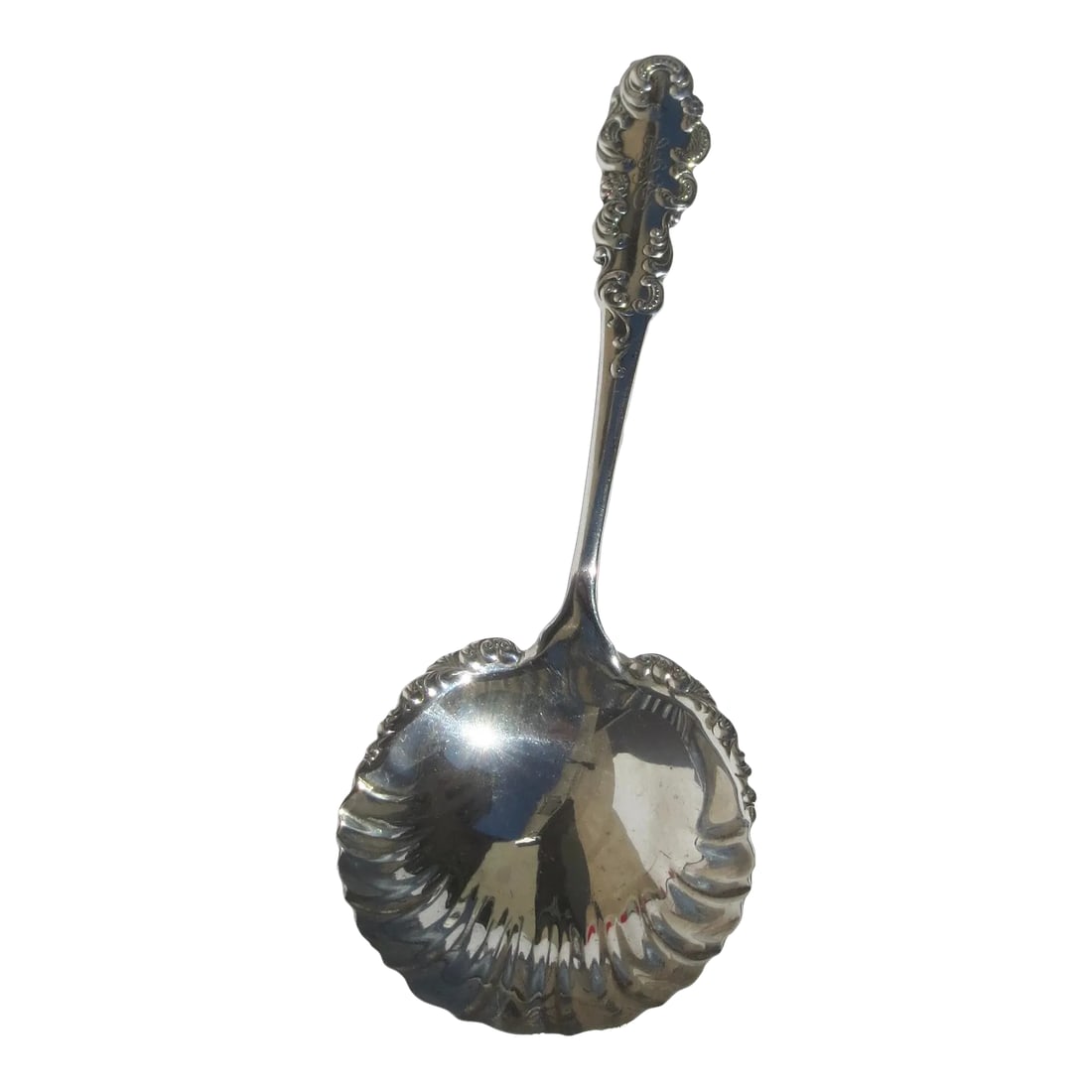 Antique Sterling Silver Serving Spoon Circa 1915: Sterling silver serving spoon by Black International circa 1915. Scalloped bowl rim with Beaux Arts designs and scrolling edges. Monogrammed with H R G to the top of the handle. Deep bowl to the