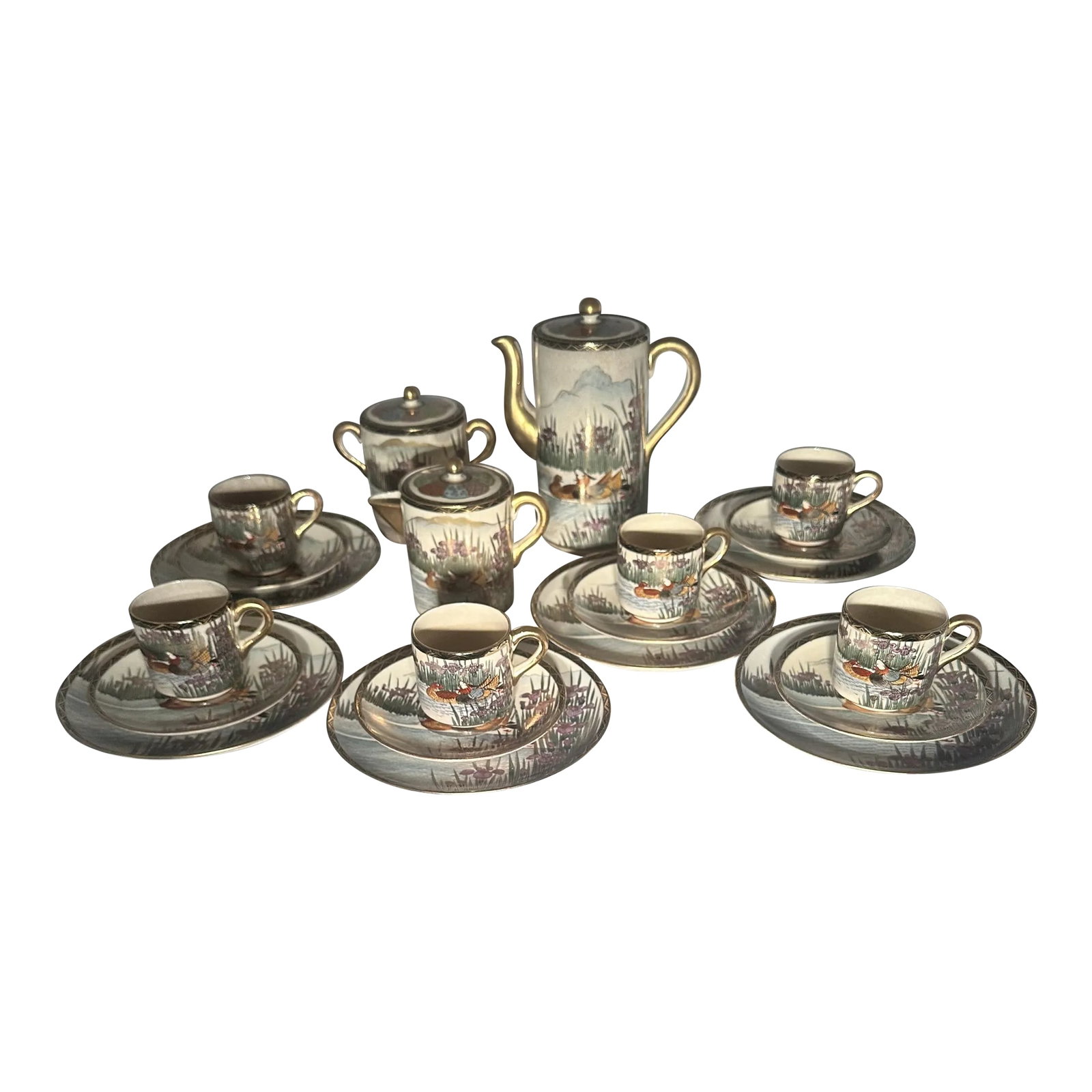 Early 1900s Japanese Satsuma Ducks and Iris Coffee Dessert Service- 21 Pieces: Japanese Satsuma porcelain. Taisho Period (1912-1926). Ducks in pond and Mt. Fuji on reverse. Purple irises around. Demitasse coffee dessert service includes: Demitasse coffee pot. 7" H Covered cream