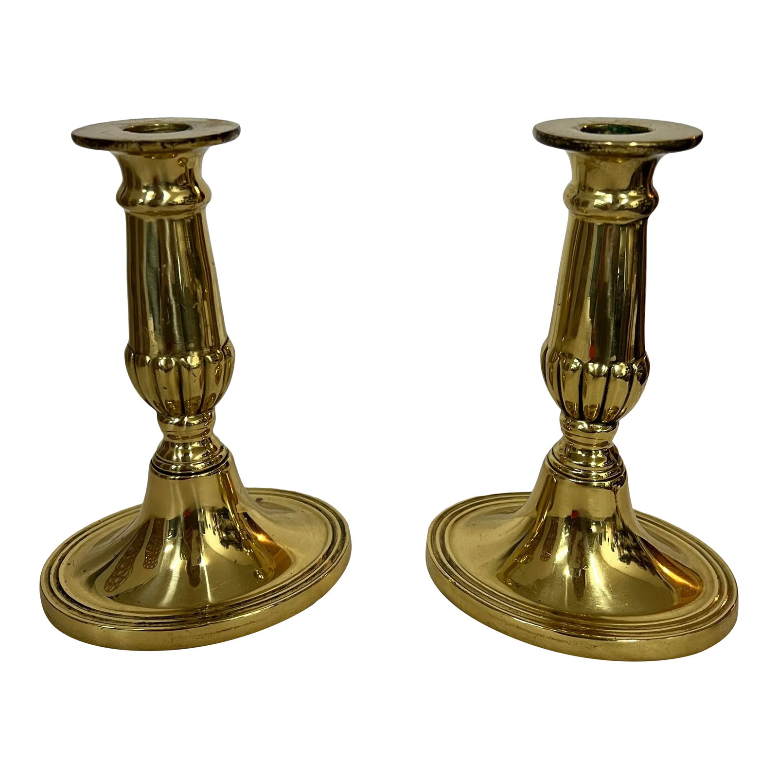 Vintage English Brass Candleholders - a Pair: Pair of vintage English brass candleholders with shiny finish and oval bases. Measure 4.5" w x 3:5" d x 6" h. Condition: Alterations: Original Condition Unaltered Imperfections: Some Imperfections