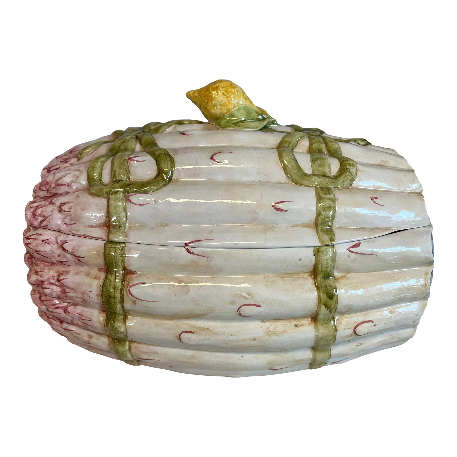 1960s Asparagus Form Italian Faience Tureen: Asparagus form Italian Faience Tureen topped with a faience lemon for lifting the lid. Decorated with bows and has space in which to put a ladle. Probably holds about 2 quarts of soup. Condition: Alte