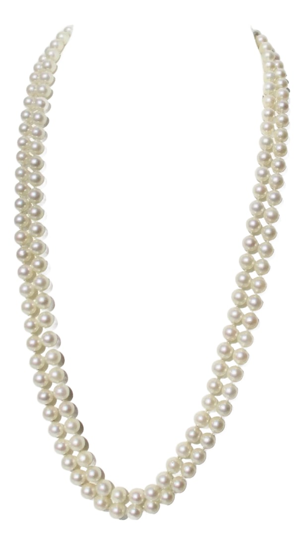 Double Stand Necklace of Cultured Pearls and 14 Kt Clasp: Double strand of cultured pearls with a 14Kt yellow gold clasp. The strands are 7mm pearls, and the length is 24" each. Beautiful, creamy, lustrous knotted strands. INV 64th Comp Condition: Alteration