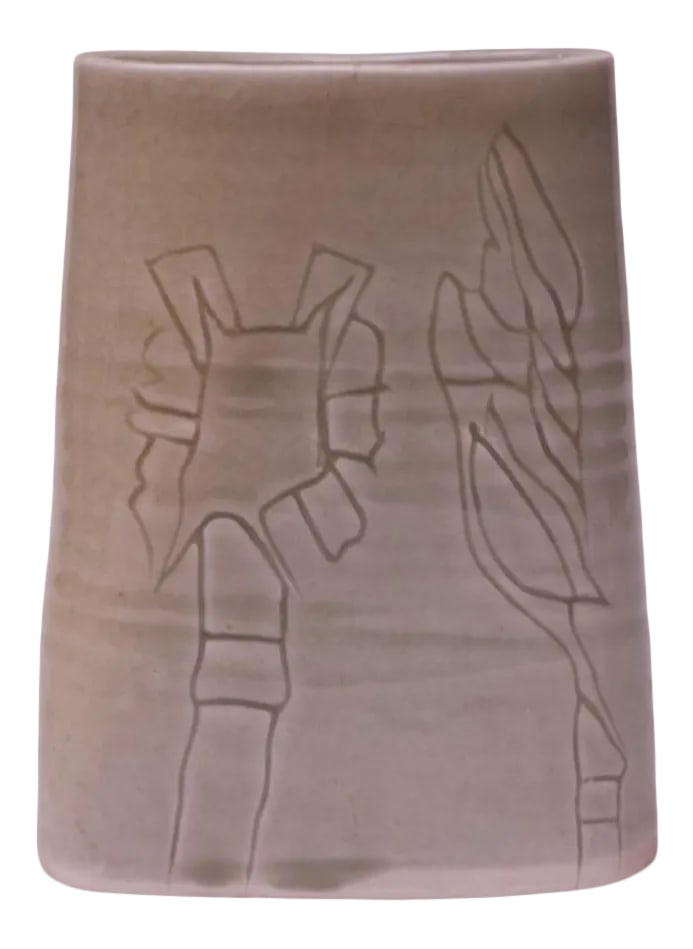 Studio Stoneware Pale Green Floral Vase Signed Pollack, 1976: Pale green stoneware vase made in 1976 by ceramicist, Pollack. Abstract floral decoration present on both sides. Signed "Pollack '76." Dimensions Height: 7.75 in. Width: 6 in. Depth: 2.1 in.