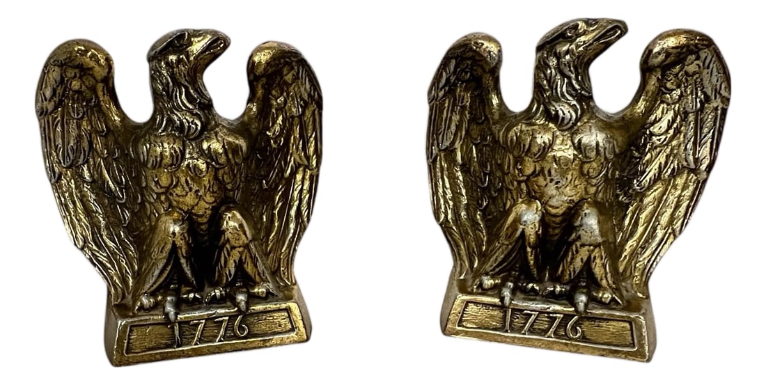 Vintage 1776 Eagle Bookends - A Pair: Vintage gold finish Colonial Williamsburg 1776 eagle bookends. Each measures 6" w x 3" d x 6" h. Some tarnish and loss of gold color, typical with age. Made in Virginia, U.S. Condition: Alterations: O