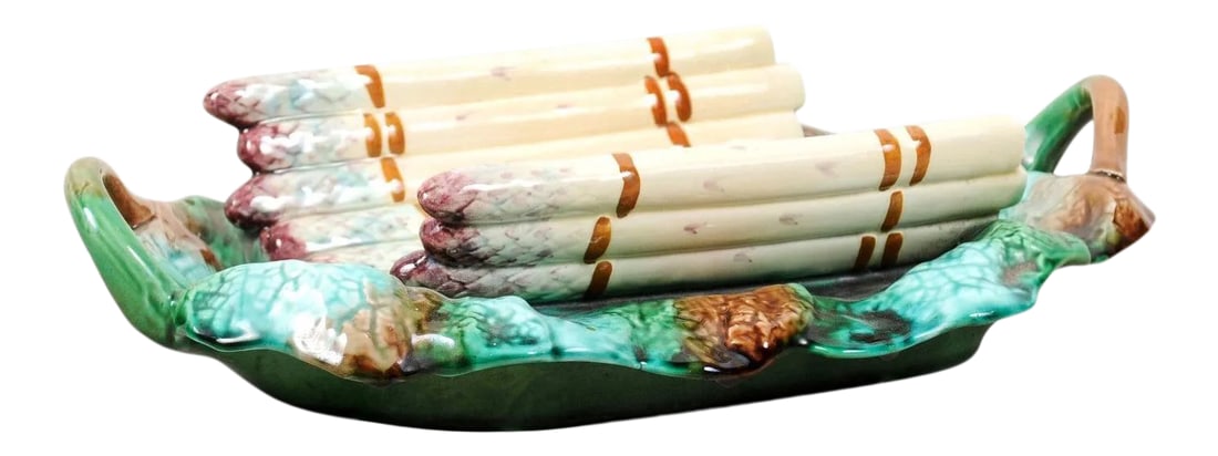 French 19th Century Longchamp Majolica Asparagus Server with Foliage Platter: A French Longchamp Majolica asparagus server from the 19th century, with green, purple and brown tones. Created in France during the 19th century, this Majolica server features a curving cradle adorne