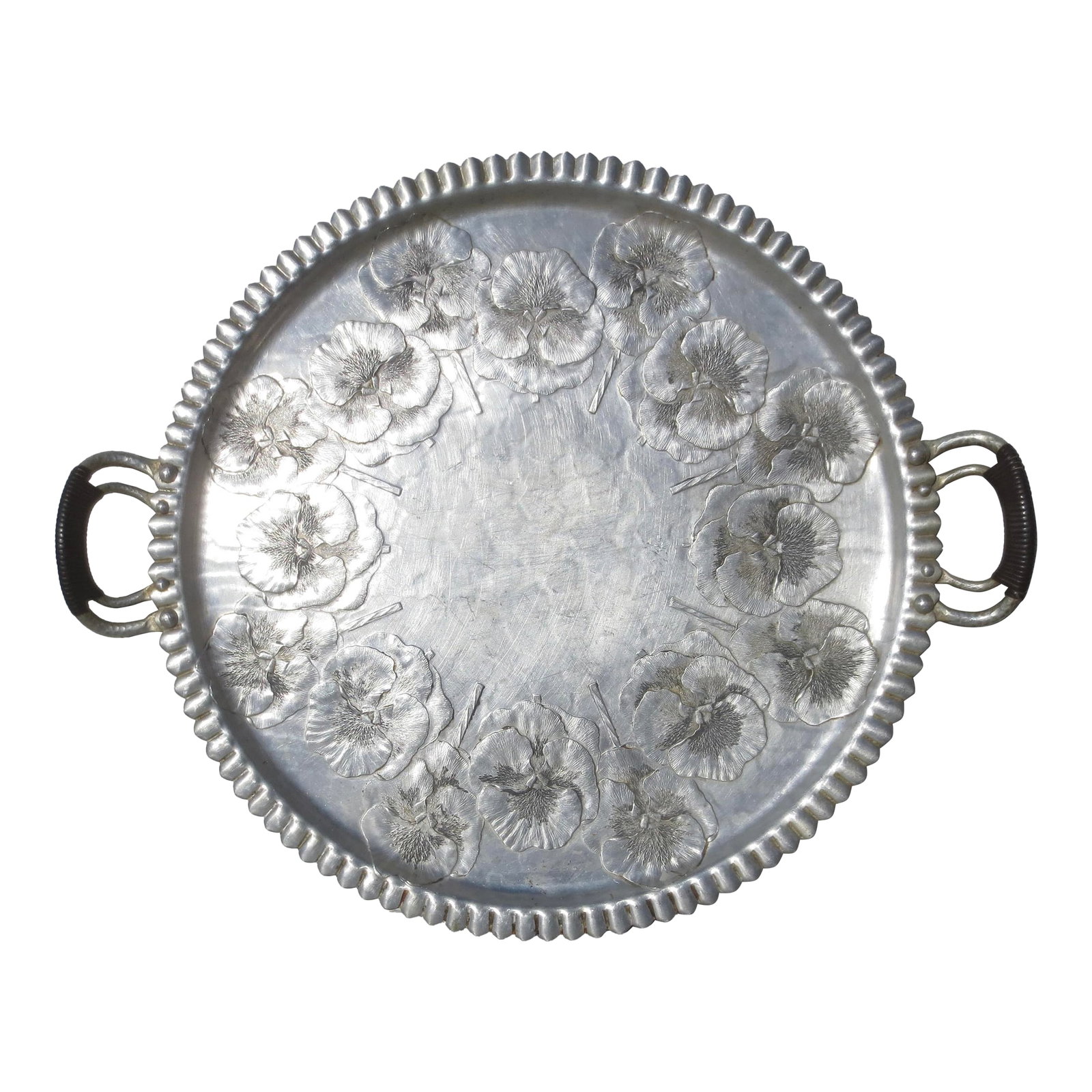Hand Made Alimunim Tray Circa 40s by Continental: Vintage tray with poppy pattern and vinyl wrapped handles. Unique pattern by Continental Trade mark and Hand Wrought 1053. Scalloped rim and double handles. The measurements are 15.5 in diameter and 1