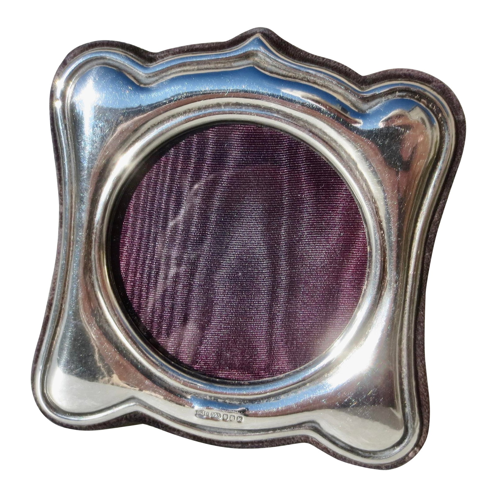 Sterling Silver Edinburgh 1984: Sterling silver marked Edinburgh 1984. Circular window with a square glass inside. The measurements are 3.5" by 3.5". Dark purple velvet back and stand. INV 64th Condition: Alterations: Original