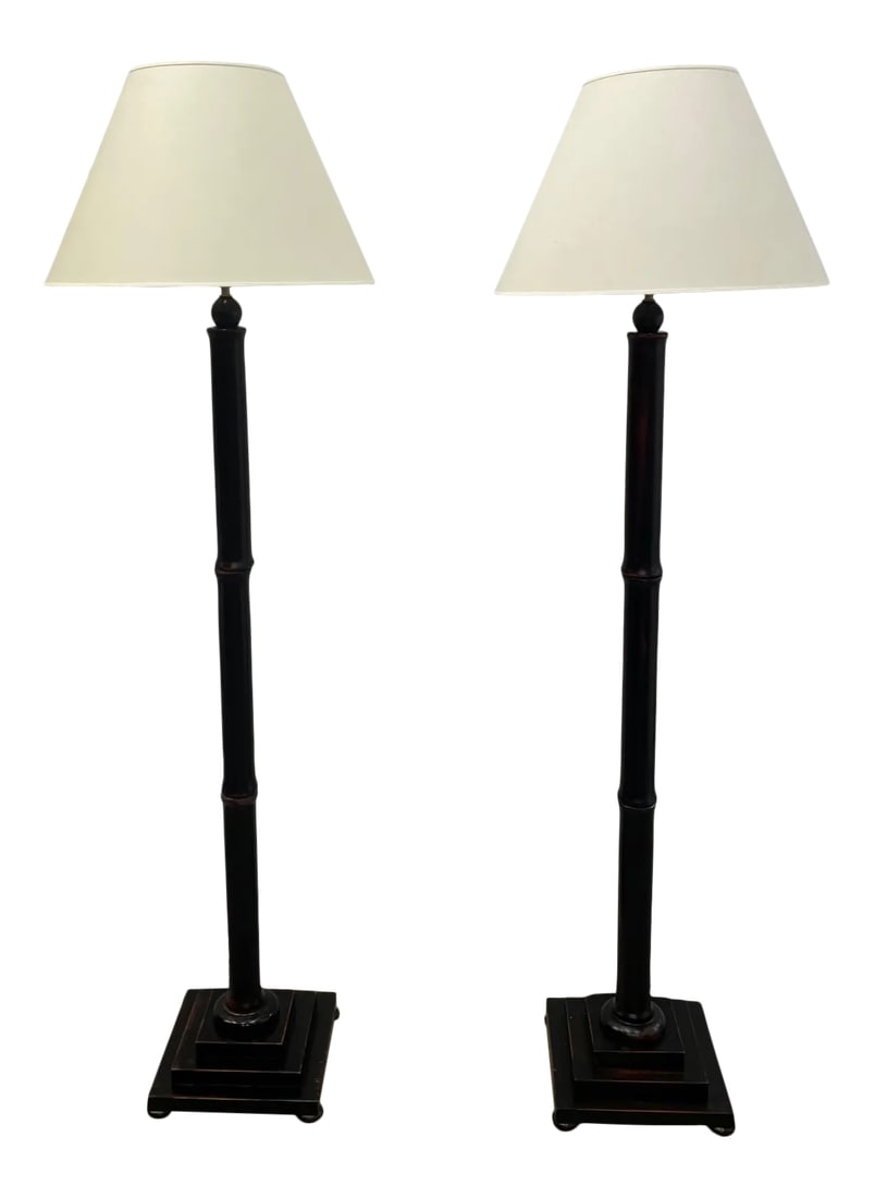 Faux Bamboo Wooden Floor Lamps With Black Finish -A Pair: A matching pair of vintage faux bamboo floor lamps having a handsome black rubbed finish. Shades not included. Top of socket 62; top of harp 73. Condition: Alterations: Original Condition Unaltered