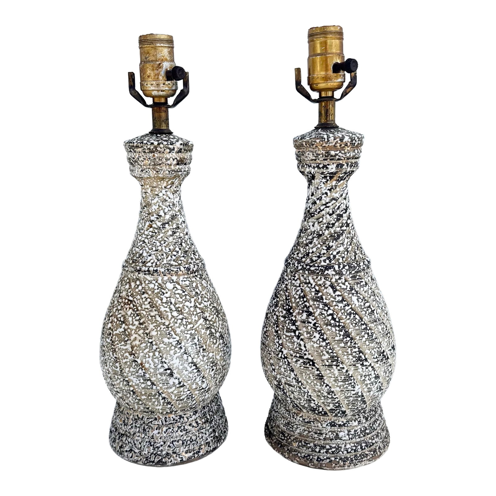 Mid Century Modern Splatter Glazed Swirl Table Lamps - A Pair: A striking pair of Mid-Century Modern table lamps featuring sculptural bottle-form silhouettes enhanced by a richly textured splatter glaze finish. The dynamic swirling pattern of black, cream, and