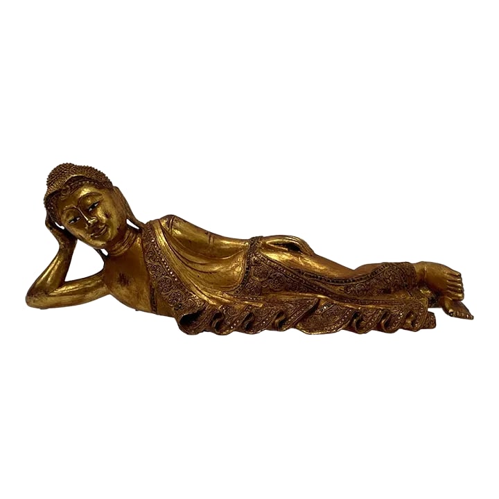 Hand Carved Giltwood Reclining Buddha on Custom Lucite Base: An unusual and striking giltwood sculpture of a reclining Buddha with head on one bent arm, lovely from every angle. Small glass beads are a decorative embellishment. A custom frosted lucite stand