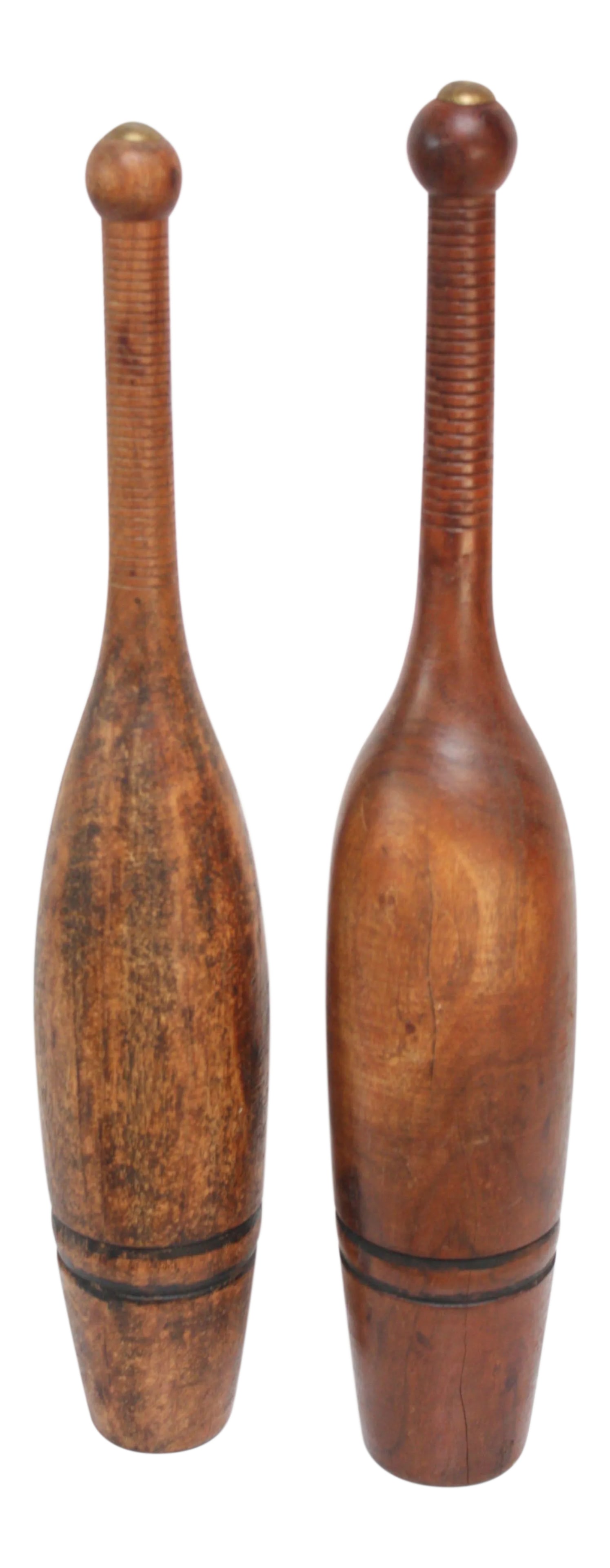 Antique Indian Juggling Pins - A Pair: Similar hand-carved early 20th century Indian juggling pins. Originally made popular in the late 19th century in Europe as weights for exercise, the trend migrated to the US in the beginning of the
