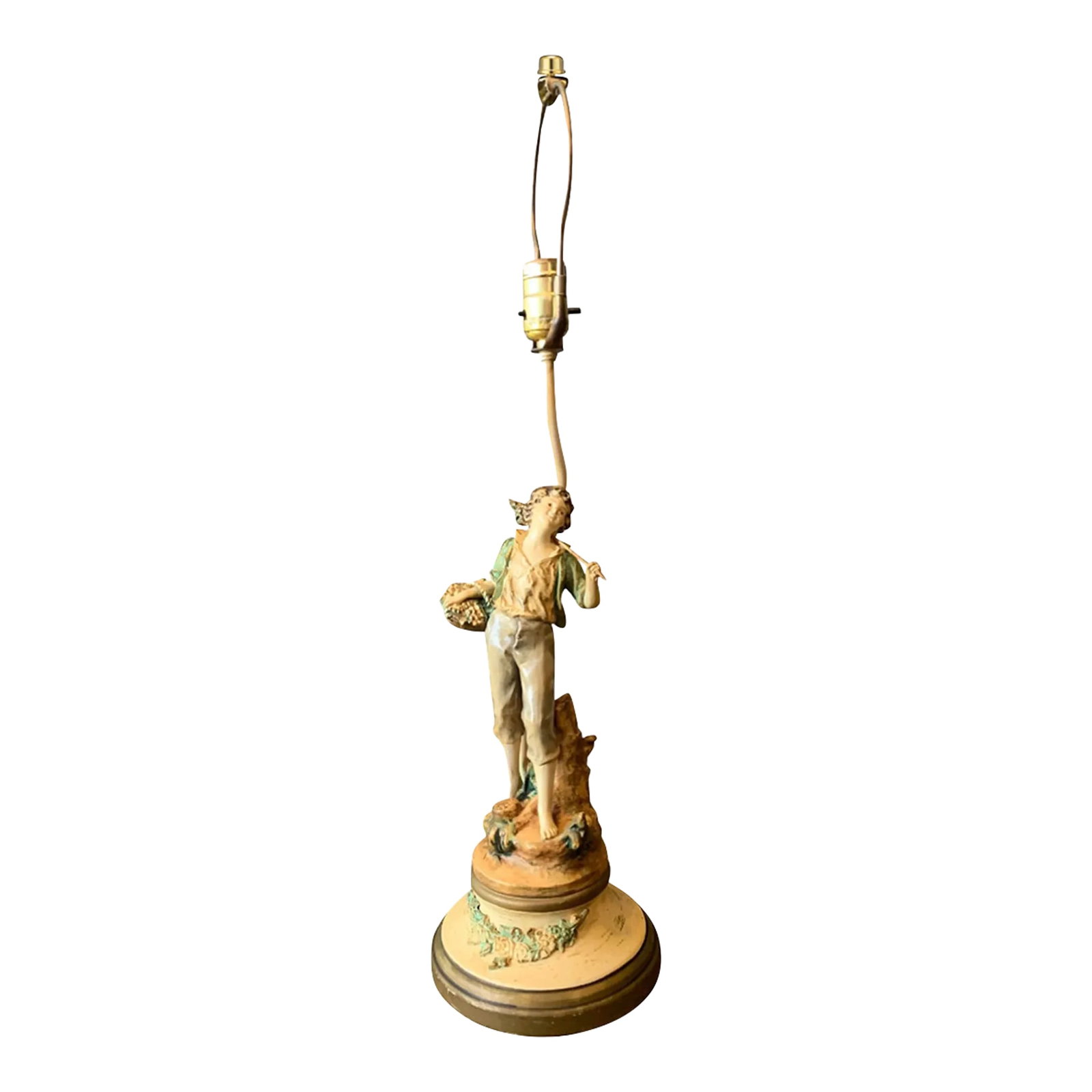 Vintage Moreau Spelter Table Lamp: Boy With Basket: This enchanting lamp captures the spirit of a youthful village boy dressed in rustic brown knickers and a light green shirt layered over a white undershirt. A woven basket hangs casually from his righ