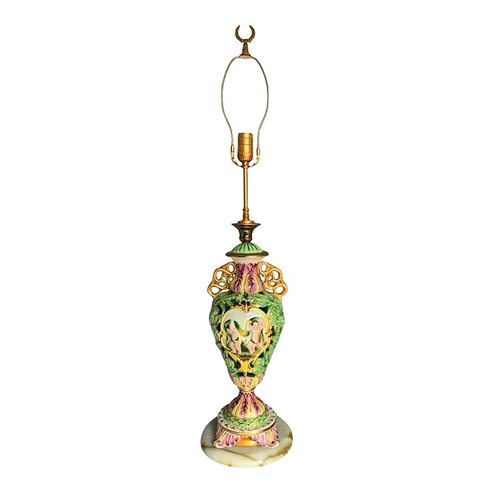Mid-Century Capodimonte Reticulated Porcelain Cherub Table Lamp: This Mid-century Capodimonte reticulated porcelain piece showcases exquisite Italian craftsmanship. The curved body features a delicate perforated design of green leaves with subtle gold highlights. O