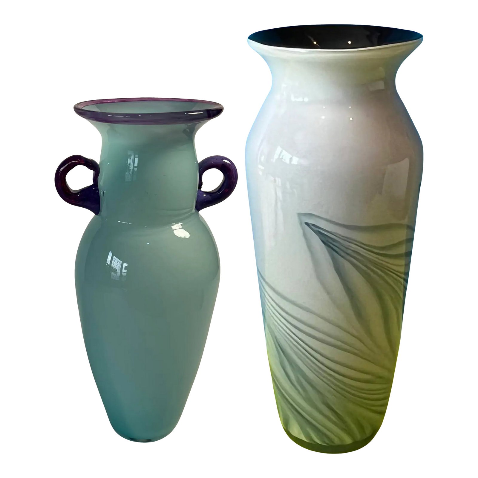 Art Glass Vases a Pair: These two handblown art glass vases are captivating showcases of artisanal mastery, each distinguished by its own character yet united by a harmonious blue-green palette. The shorter vase, standing