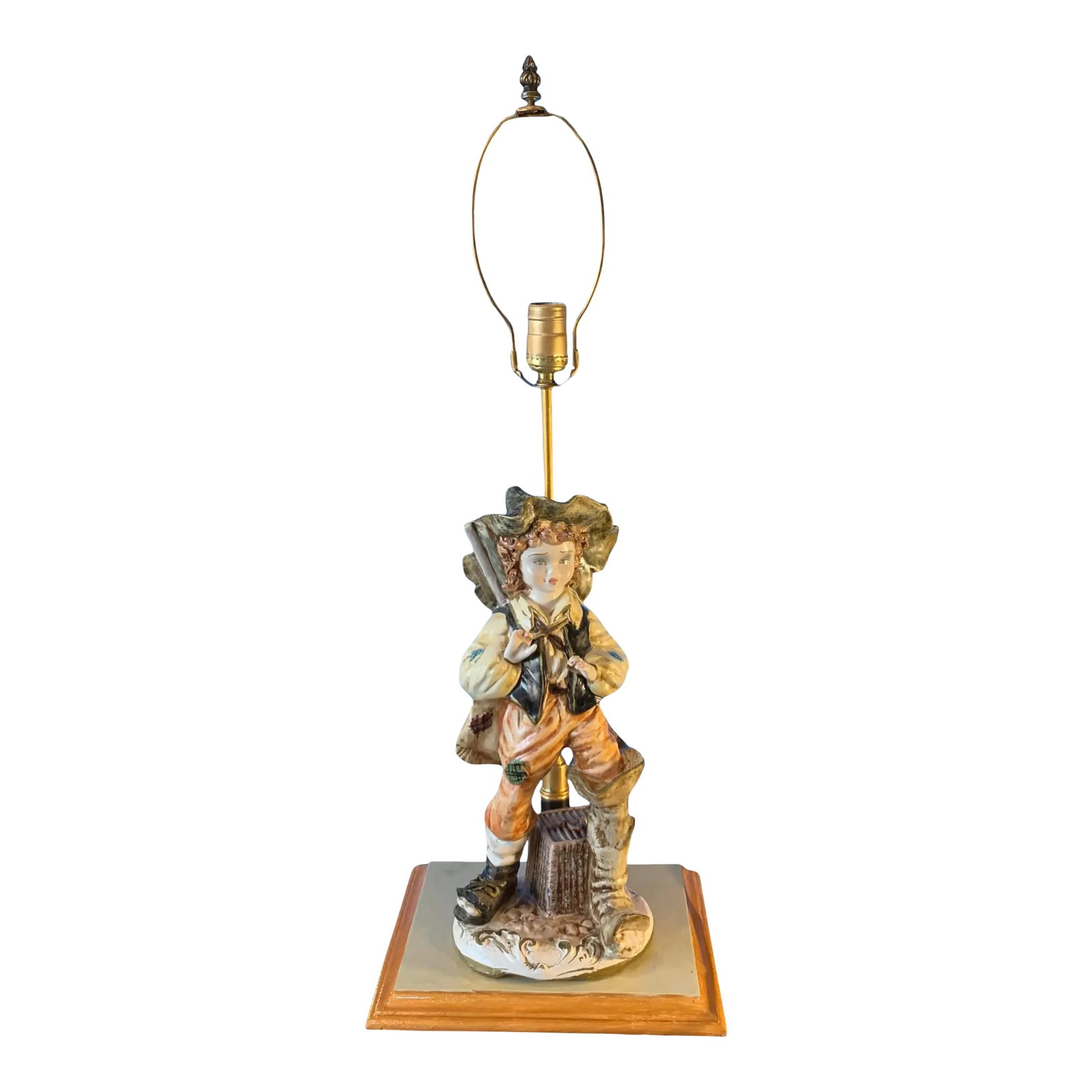 Vintage Capodimonte Porcelain Figural Lamp-Village Boy: This midcentury Capodimonte porcelain figural lamp captures the charm and innocence of rural life with its depiction of a young village boy. The centerpiece of the lamp is a finely crafted and hand-pa