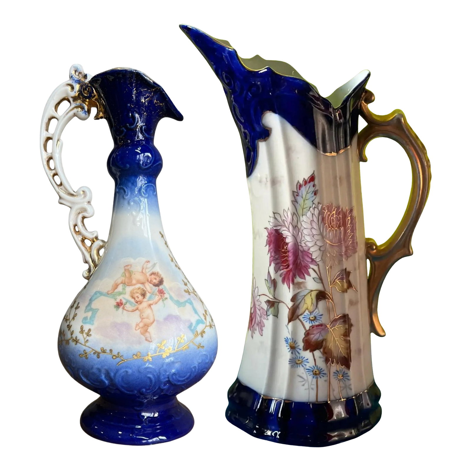 Antique Victoria Carlsbad Porcelain Floral & Cherub Ewer Vase-a Pair: A Pair of Victoria Carlsbad Austria Porcelain Ewers Circa late 19th century These two porcelain ewers, though close in size, offer distinct temperaments—one lyrical and romantic, the other bold 