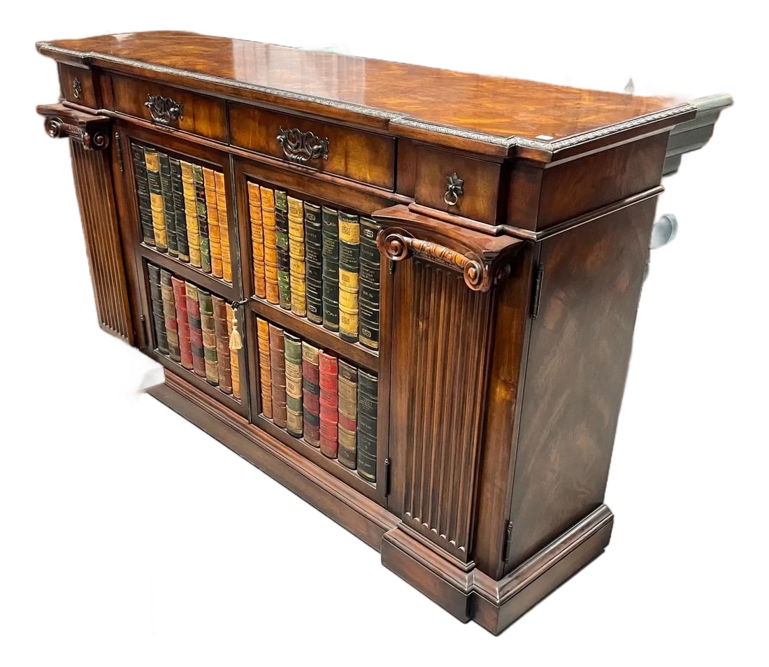 Late 20th Century Mahogany Door Cabinet With False Books on Door Fronts: This impressive door cabinet credenza was manufactured by Theodore Alexander and features two large doors faced with false book spines, which open to a generous interior with adjustable shelf
