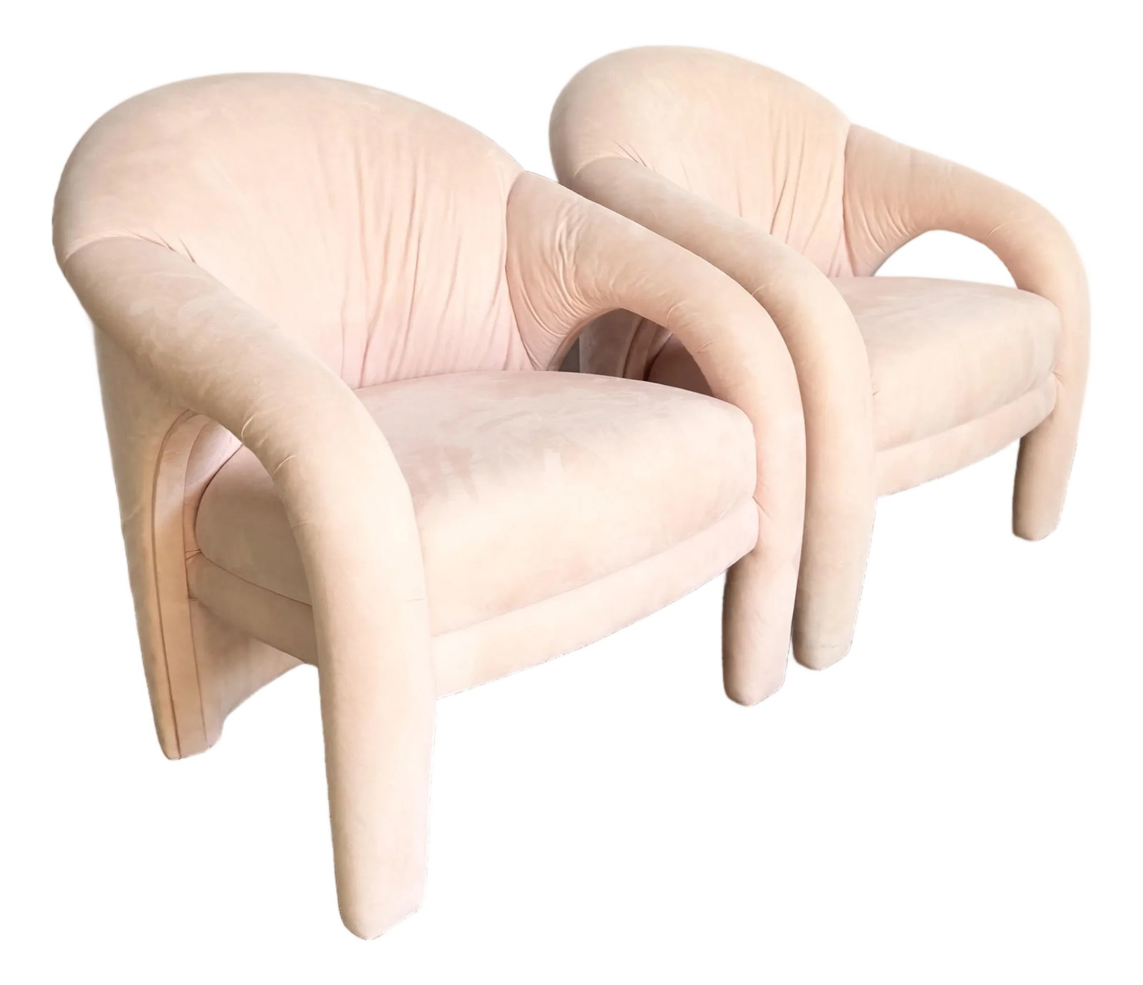 Postmodern Sculpted Pink Lounge Chairs - A Pair: A striking pair of postmodern sculpted lounge chairs upholstered in a soft blush pink. Featuring bold, rounded silhouettes with integrated arms and fluid, architectural lines, these chairs exemplify