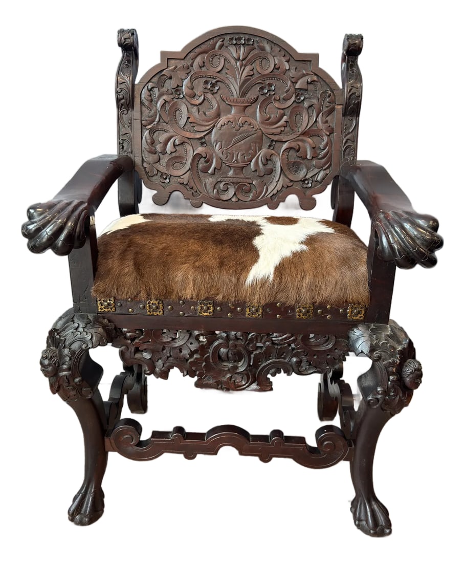 Antique Renaissance Revival Carved Walnut Throne Chair, Cowhide Seat: Rare Find! This beautiful armchair dates back to the late 19th-early 20th C. Featured intricate ornate carvings brass details along the seated trim, leather strip under the brass accents. Truly one-of