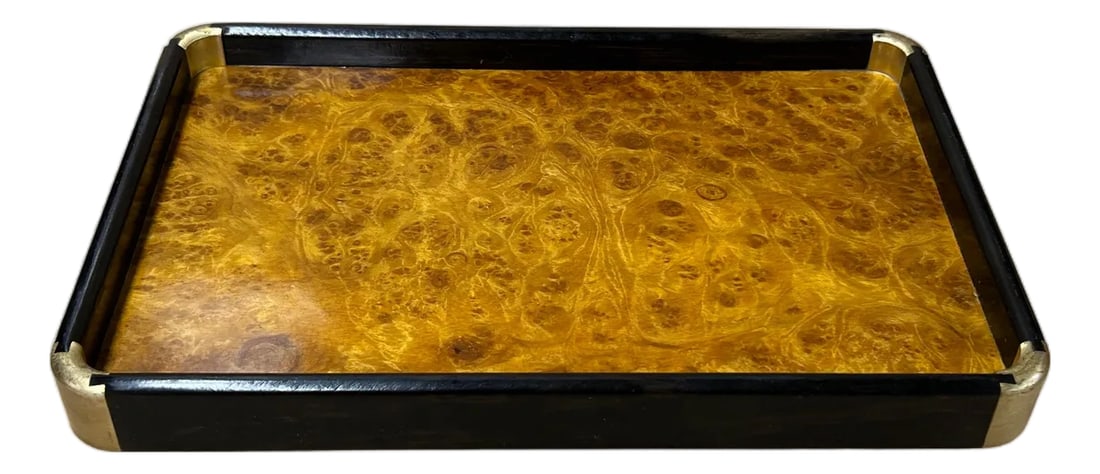 Chinoiseries Golden Brown Burl Rectangular Wood Accent Tray: This elegant rectangular valet tray showcases a sophisticated marriage of natural textures and Art Deco-inspired design. The interior surface features a rich, honey-toned burl wood veneer, defined by
