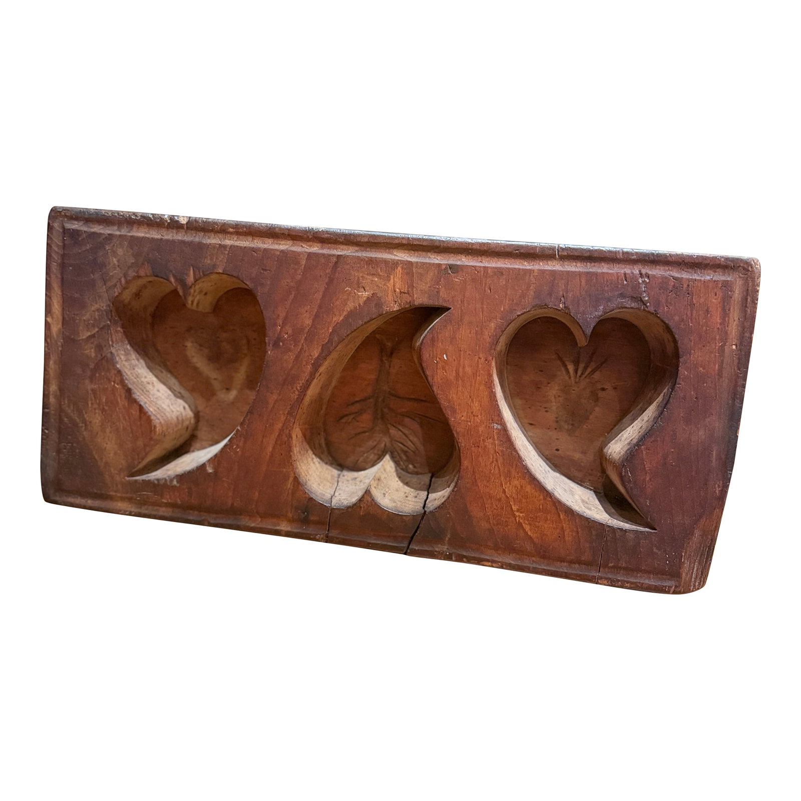 Antique Wooden Sugar Mold With Three Deep Heart Carvings: Beautiful antique Quebec wooden sugar mold featuring three deeply carved heart-shaped cavities, each decorated with traditional incised motifs including a heart, a tree, and a sacred heart design.